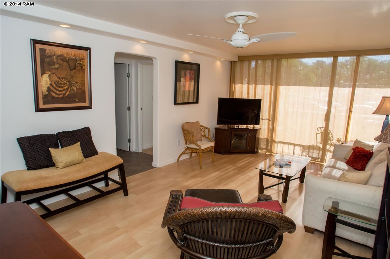 2219 South Kihei Road, Unit B214 Kihei, HI 96753 - Photo 2 of 20 a living room with furniture a flat screen tv and a window