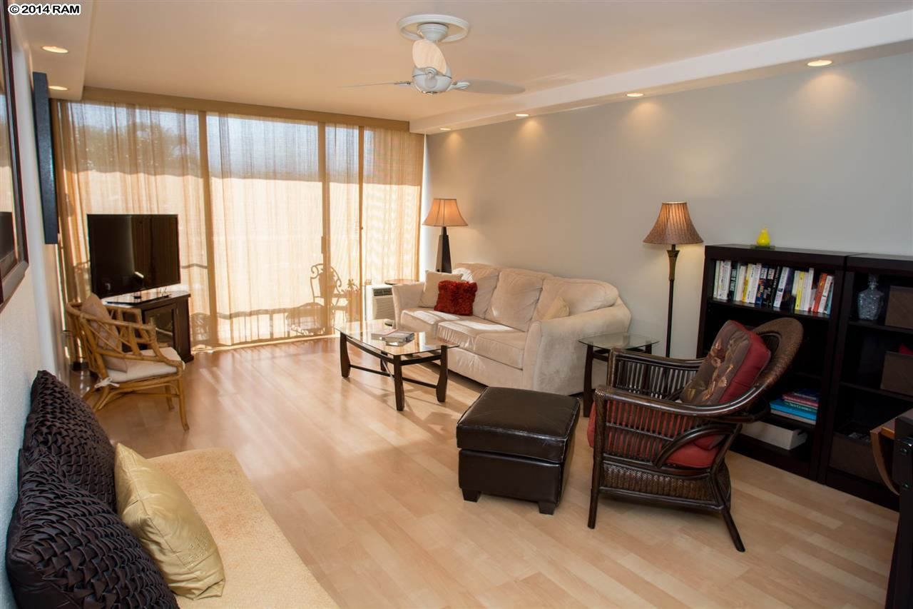 2219 South Kihei Road, Unit B214 Kihei, HI 96753 - Photo 3 of 20 a living room with furniture and a flat screen tv