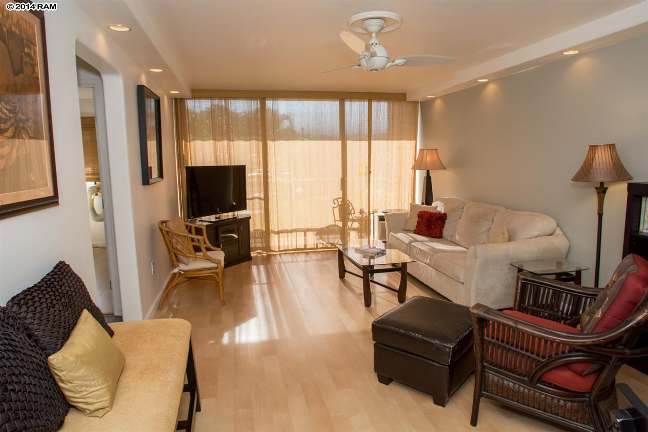 2219 South Kihei Road, Unit B214 Kihei, HI 96753 - Photo 4 of 20 a living room with furniture and a flat screen tv