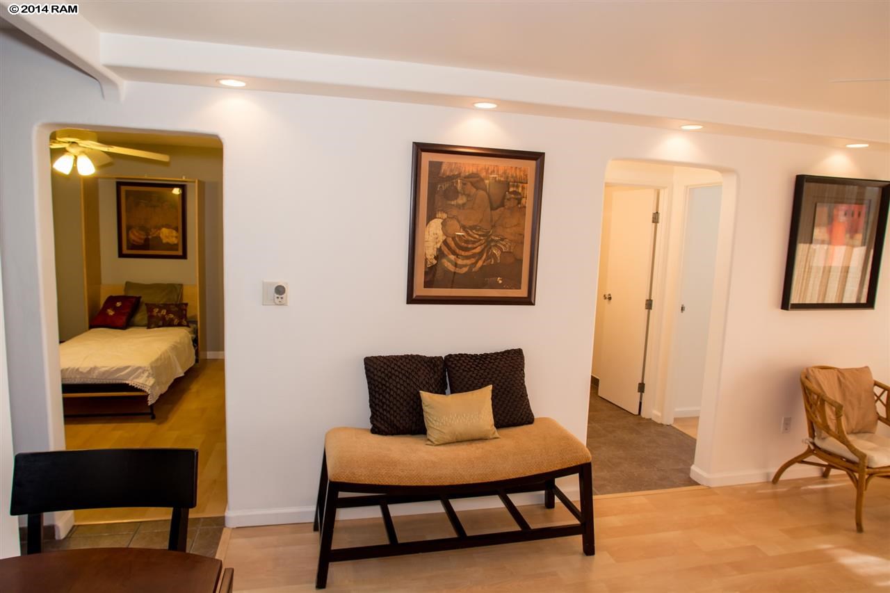 2219 South Kihei Road, Unit B214 Kihei, HI 96753 - Photo 8 of 20 a bedroom with a bed and wooden floor