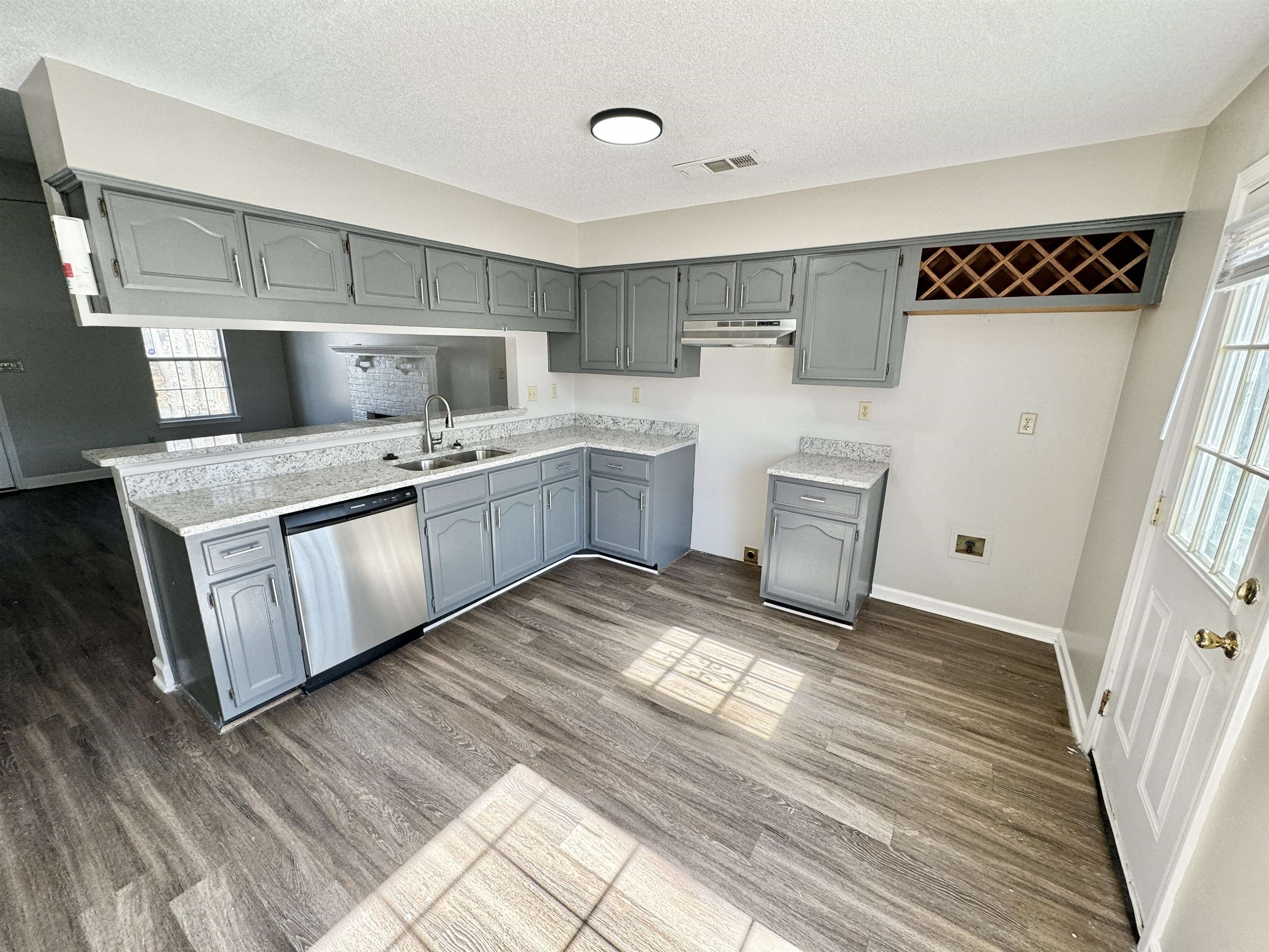 8373 Old Dexter Road Memphis, TN 38016 - Photo 6 of 26 Kitchen with a sink, visible vents, stainless steel dishwasher, gray cabinets, and dark wood finished floors