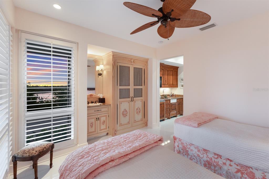 641 Boca Bay Drive Boca Grande, FL 33921 - Photo 33 of 74 a bedroom with a large bed and a chandelier