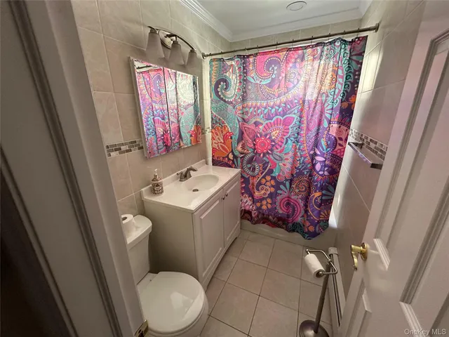 a bathroom with a sink toilet and window