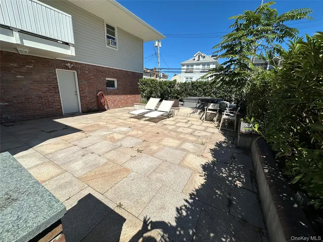 a view of a backyard with sitting area