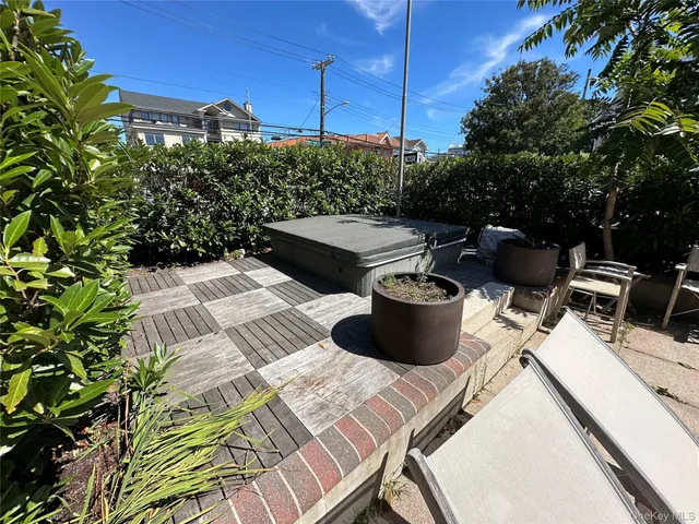 a view of a patio with table and chairs potted plants with wooden floor