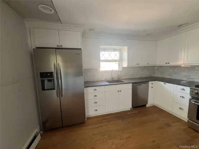 a kitchen with stainless steel appliances a refrigerator sink and cabinets