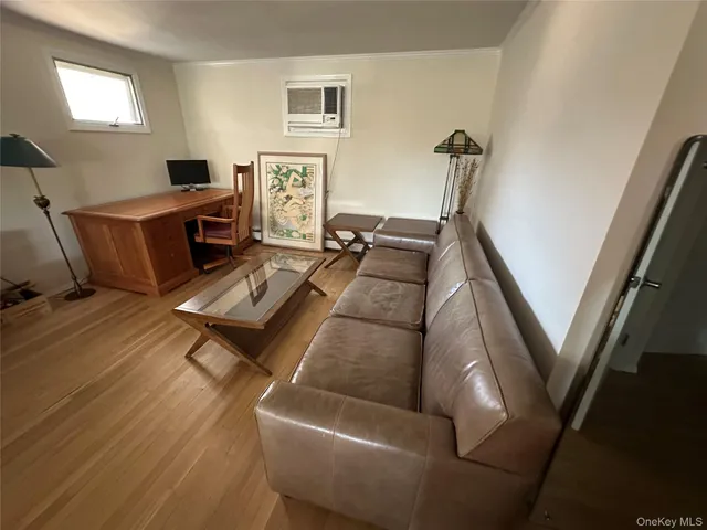a living room with furniture rug and wooden floor