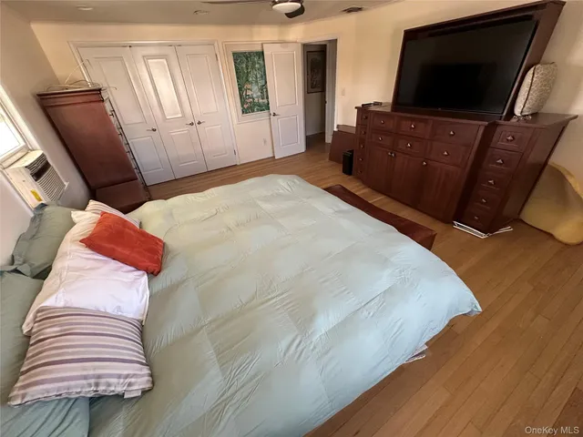 a bedroom with a bed and flat screen tv