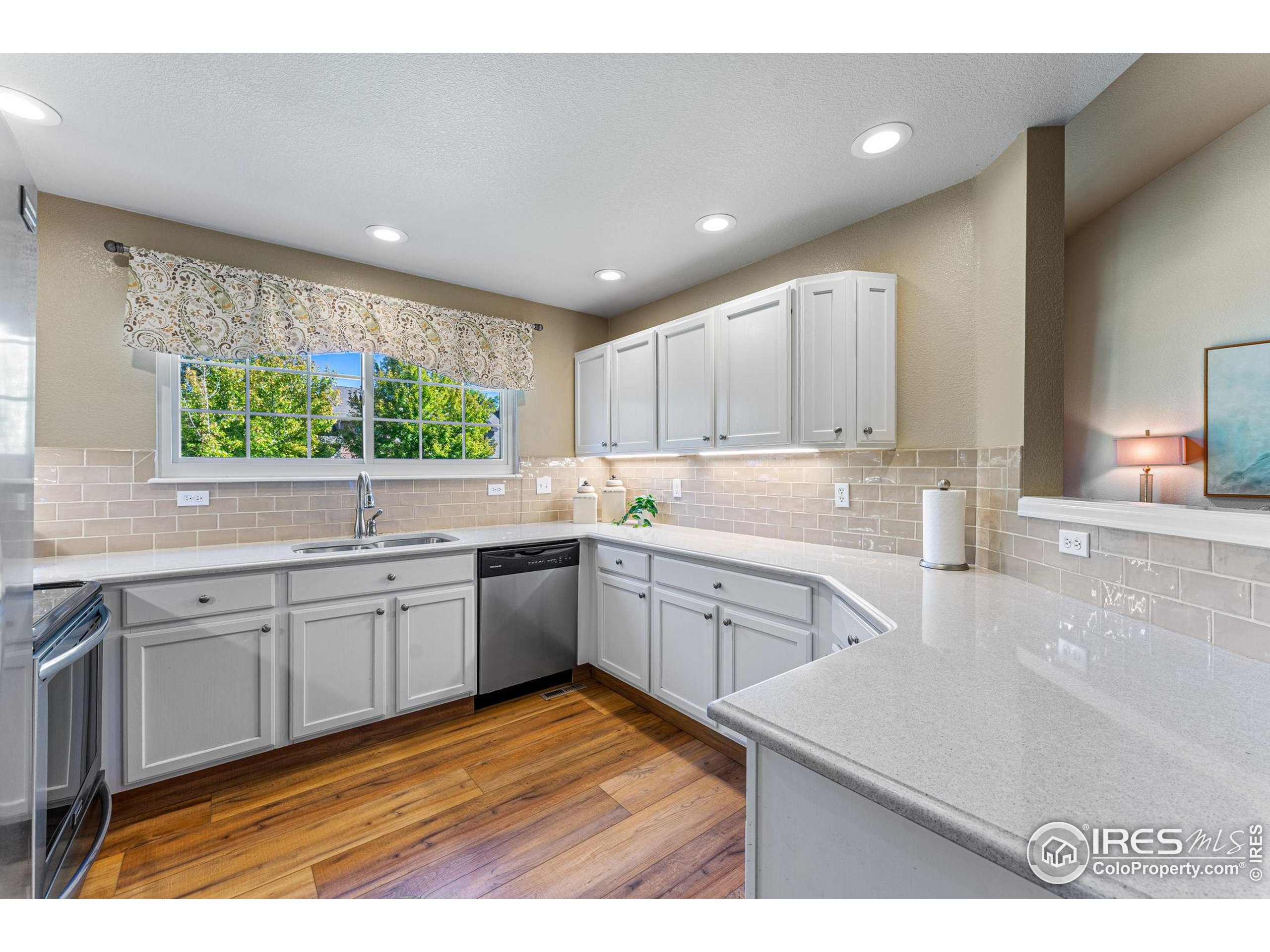 41 Quince Street Denver, CO 80230 - Photo 11 of 48 a kitchen with a sink windows and cabinets