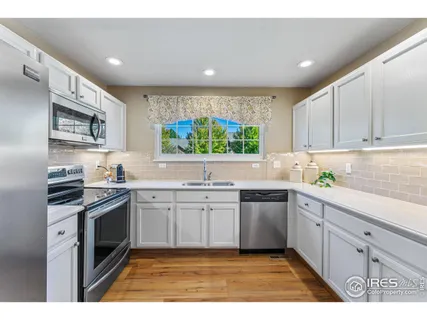 a kitchen with stainless steel appliances granite countertop a stove sink and cabinets