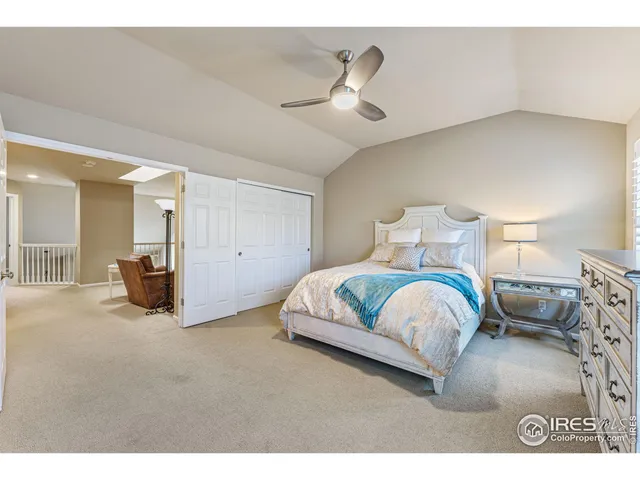 a spacious bedroom with a bed and ceiling fan