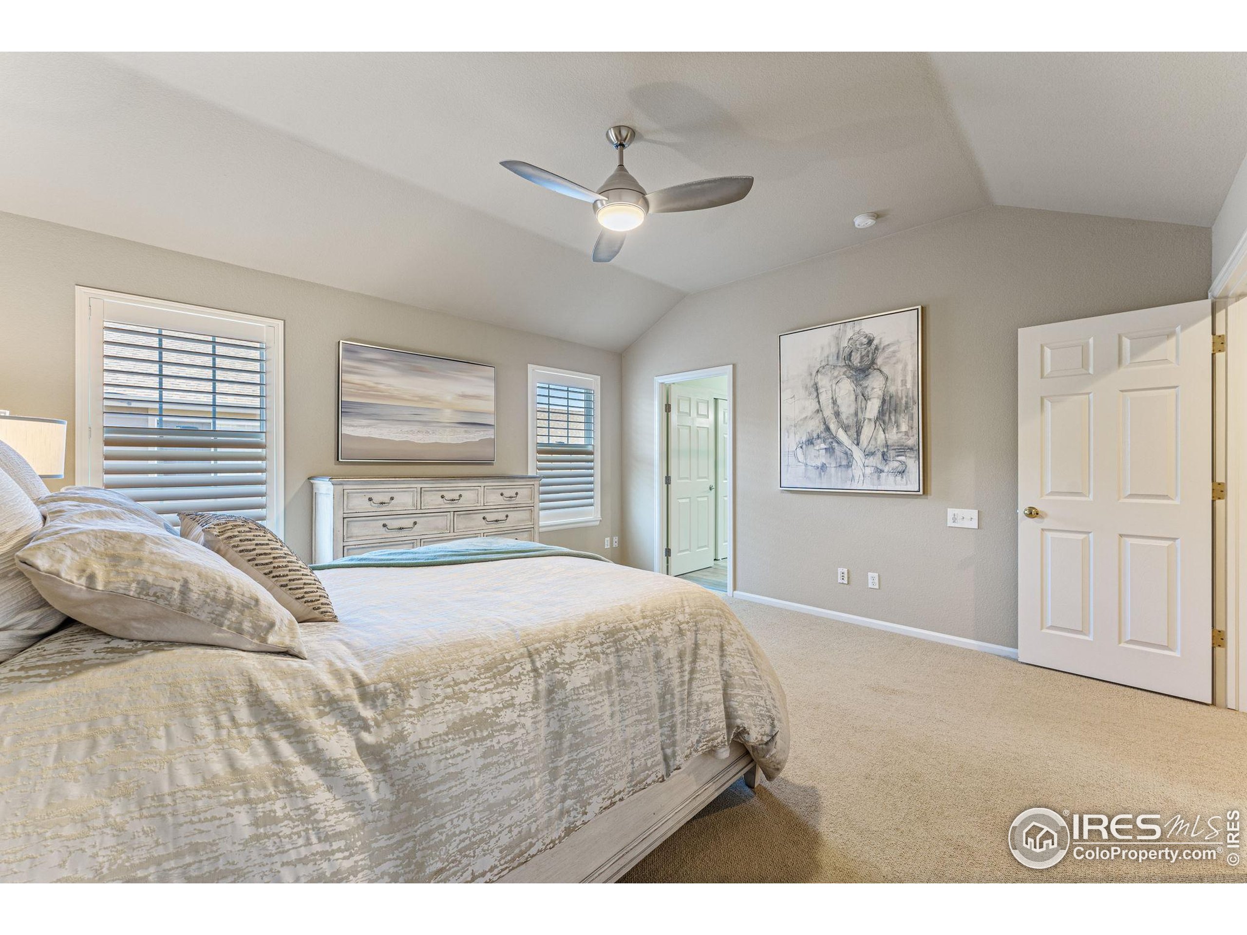 41 Quince Street Denver, CO 80230 - Photo 19 of 48 a bedroom with a large bed and a chandelier