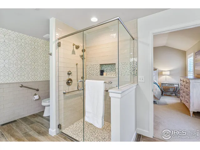 a bathroom with a glass shower door and a toilet
