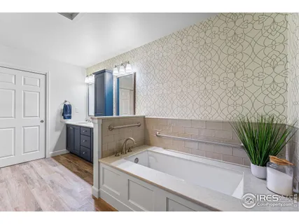 a bathroom with a bathtub sink and mirror