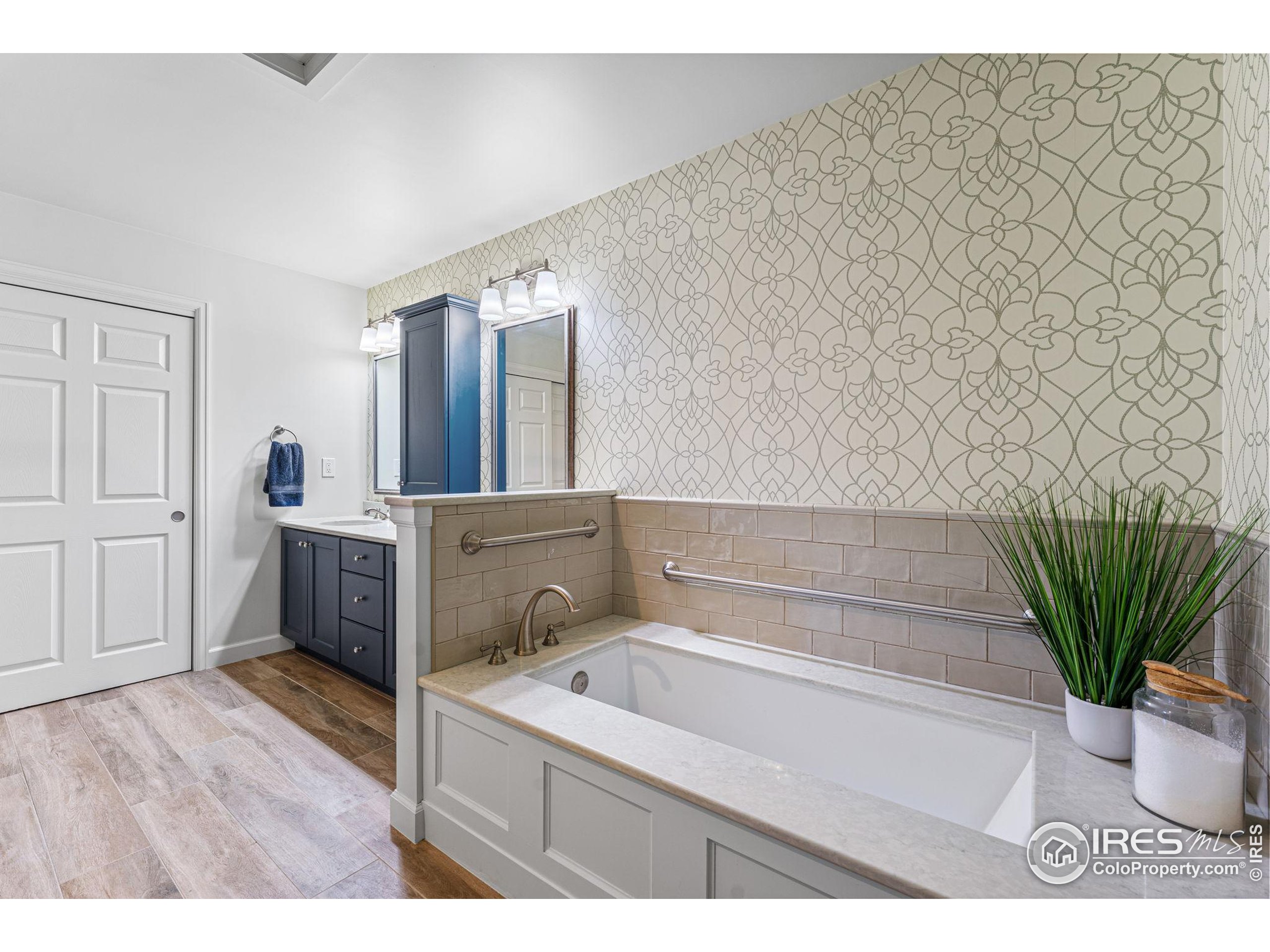 41 Quince Street Denver, CO 80230 - Photo 22 of 48 a bathroom with a bathtub sink and mirror