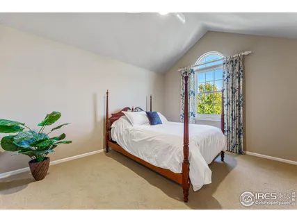 a bed room with a bed and a potted plant