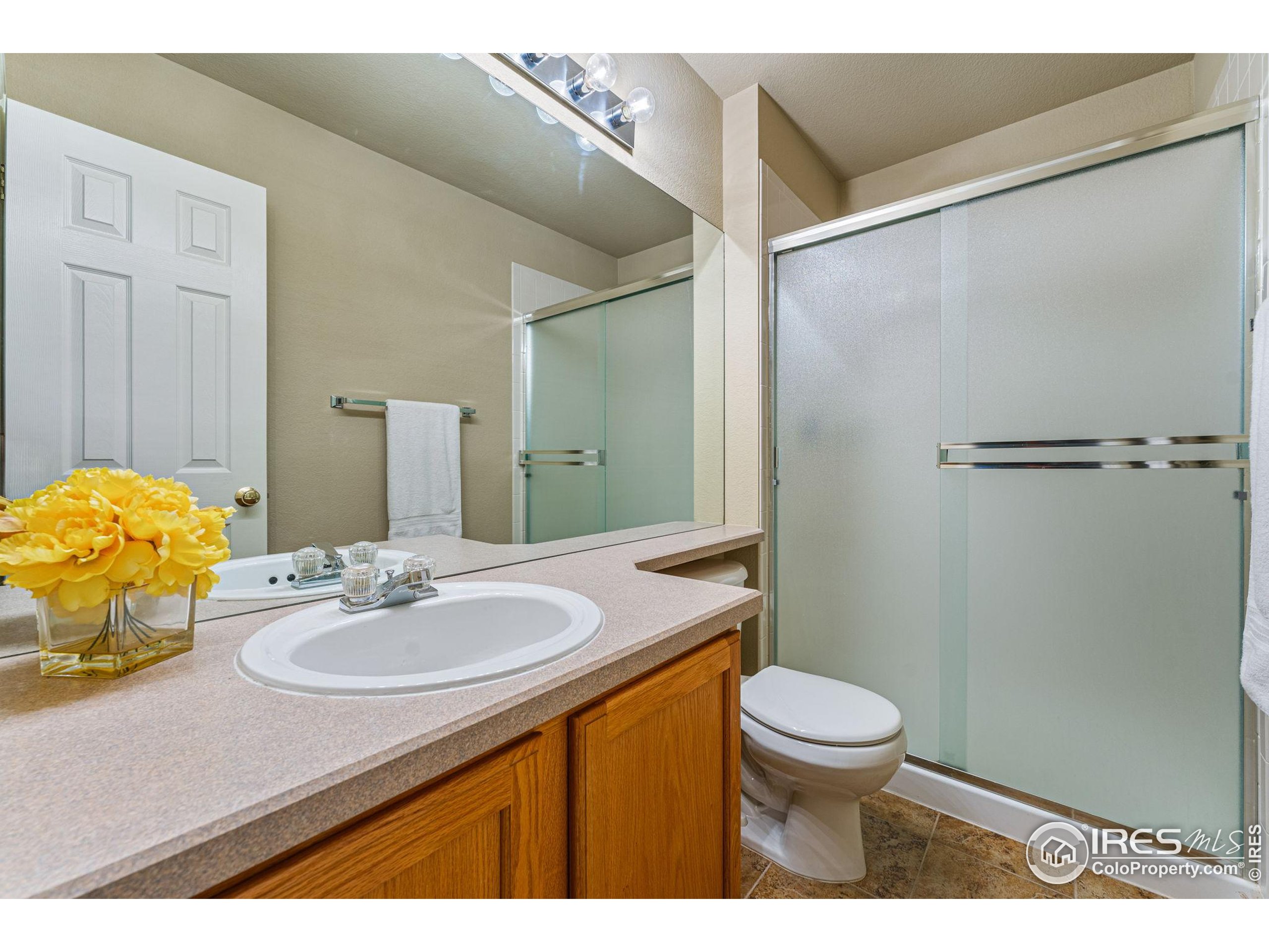 41 Quince Street Denver, CO 80230 - Photo 24 of 48 a bathroom with a sink toilet and shower