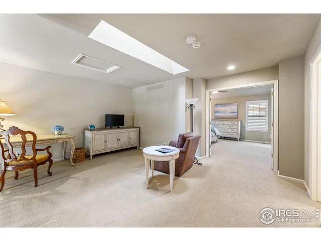 a living room with furniture and a chair