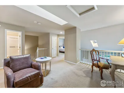 a living room with furniture and a chair