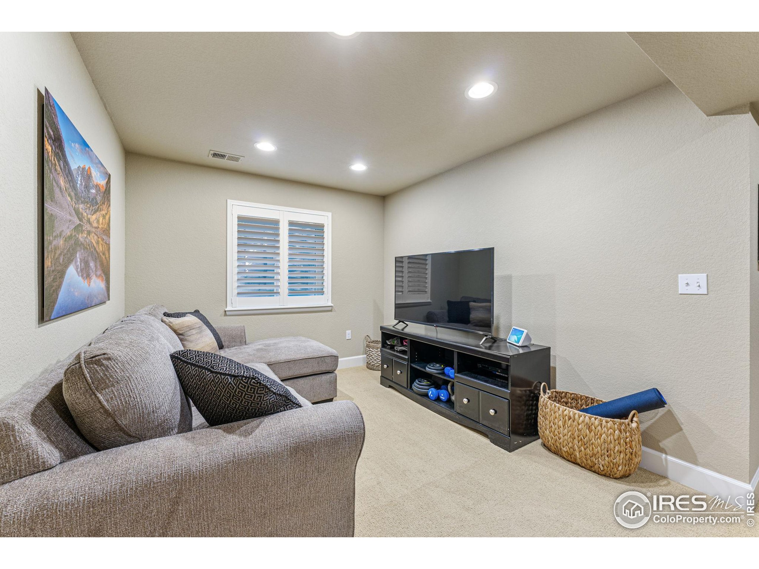 41 Quince Street Denver, CO 80230 - Photo 29 of 48 a living room with furniture and a flat screen tv