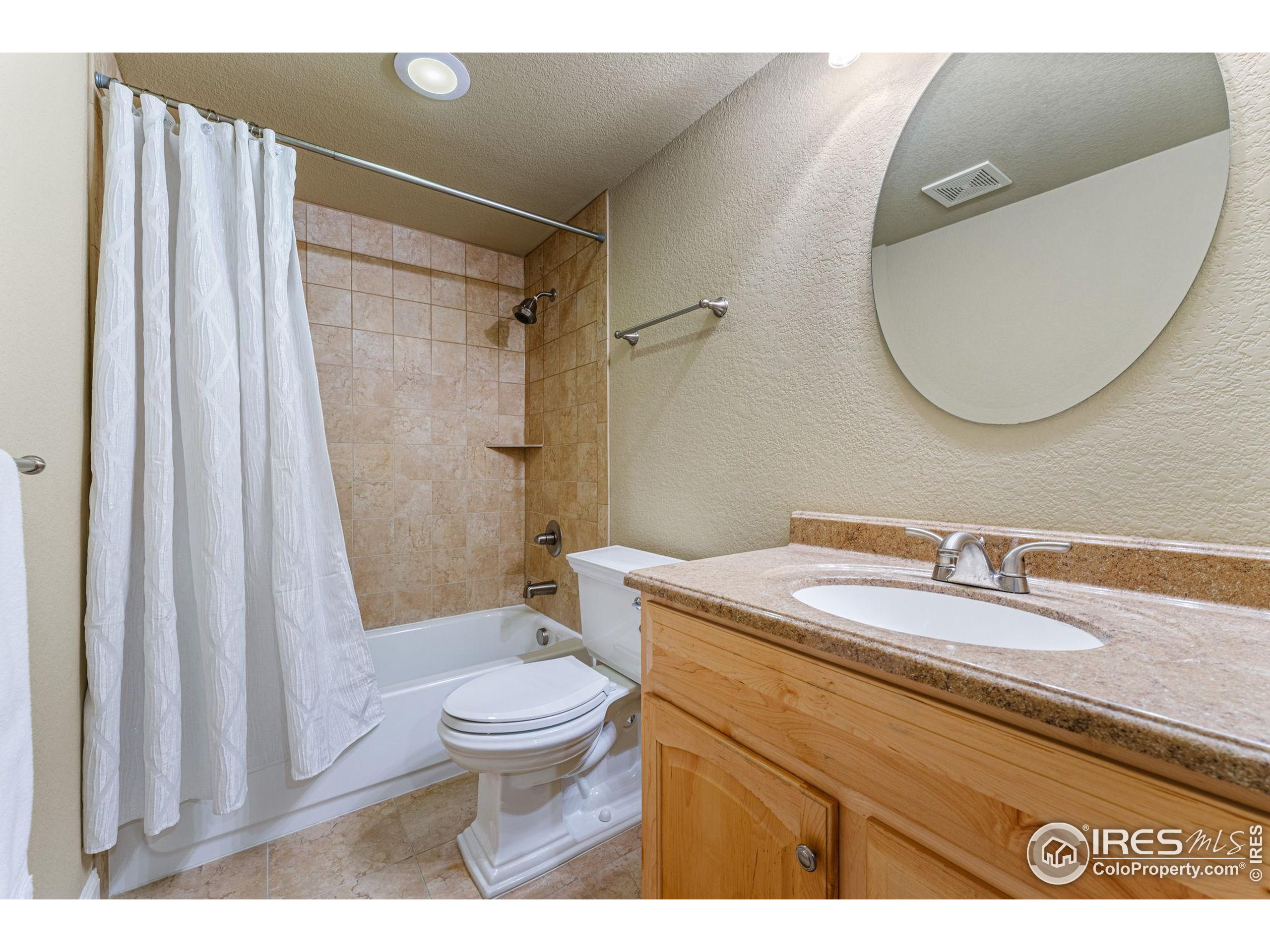 41 Quince Street Denver, CO 80230 - Photo 30 of 48 a bathroom with a sink a toilet and a mirror