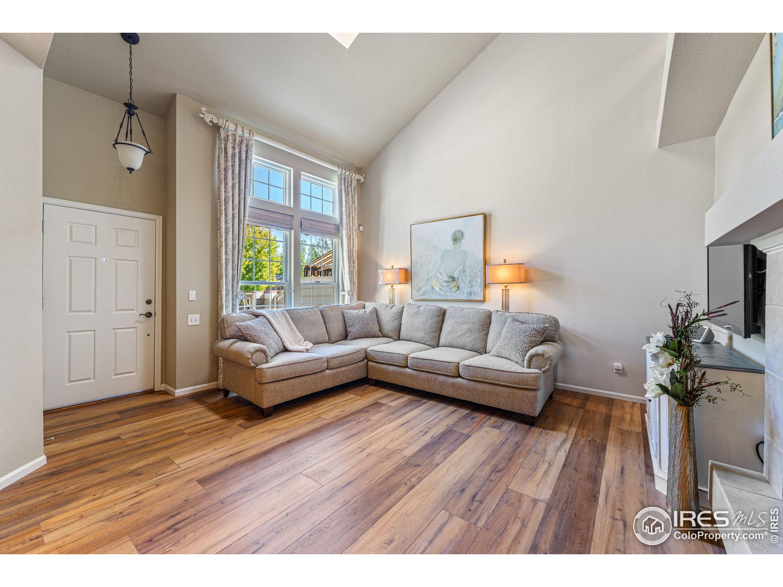 41 Quince Street Denver, CO 80230 - Photo 6 of 48 a living room with furniture and a wooden floor