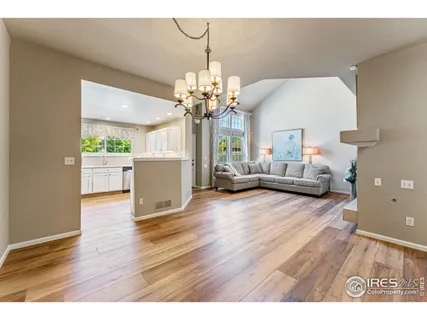a living room with furniture and a chandelier