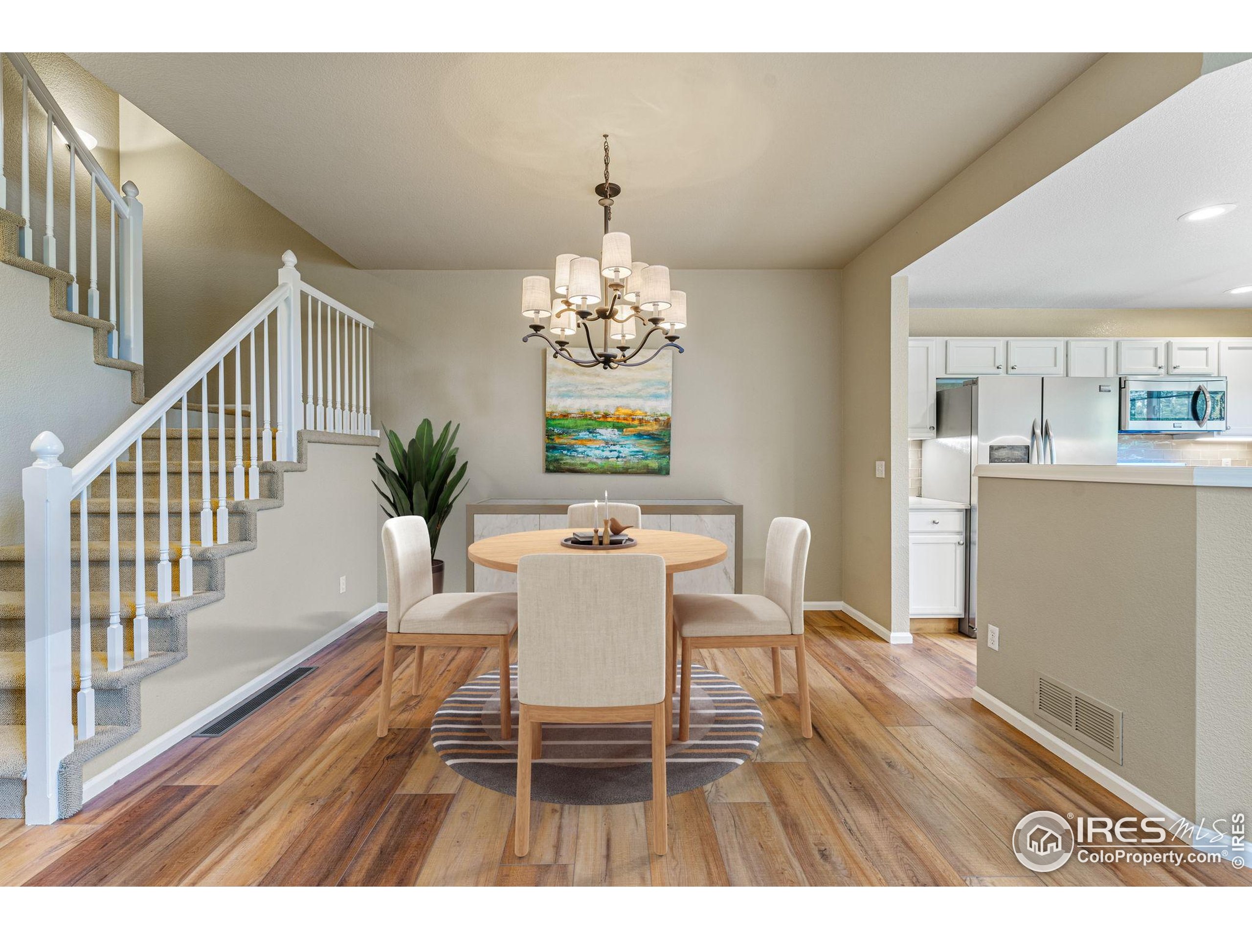 41 Quince Street Denver, CO 80230 - Photo 10 of 48 a dining room with furniture a chandelier and wooden floor