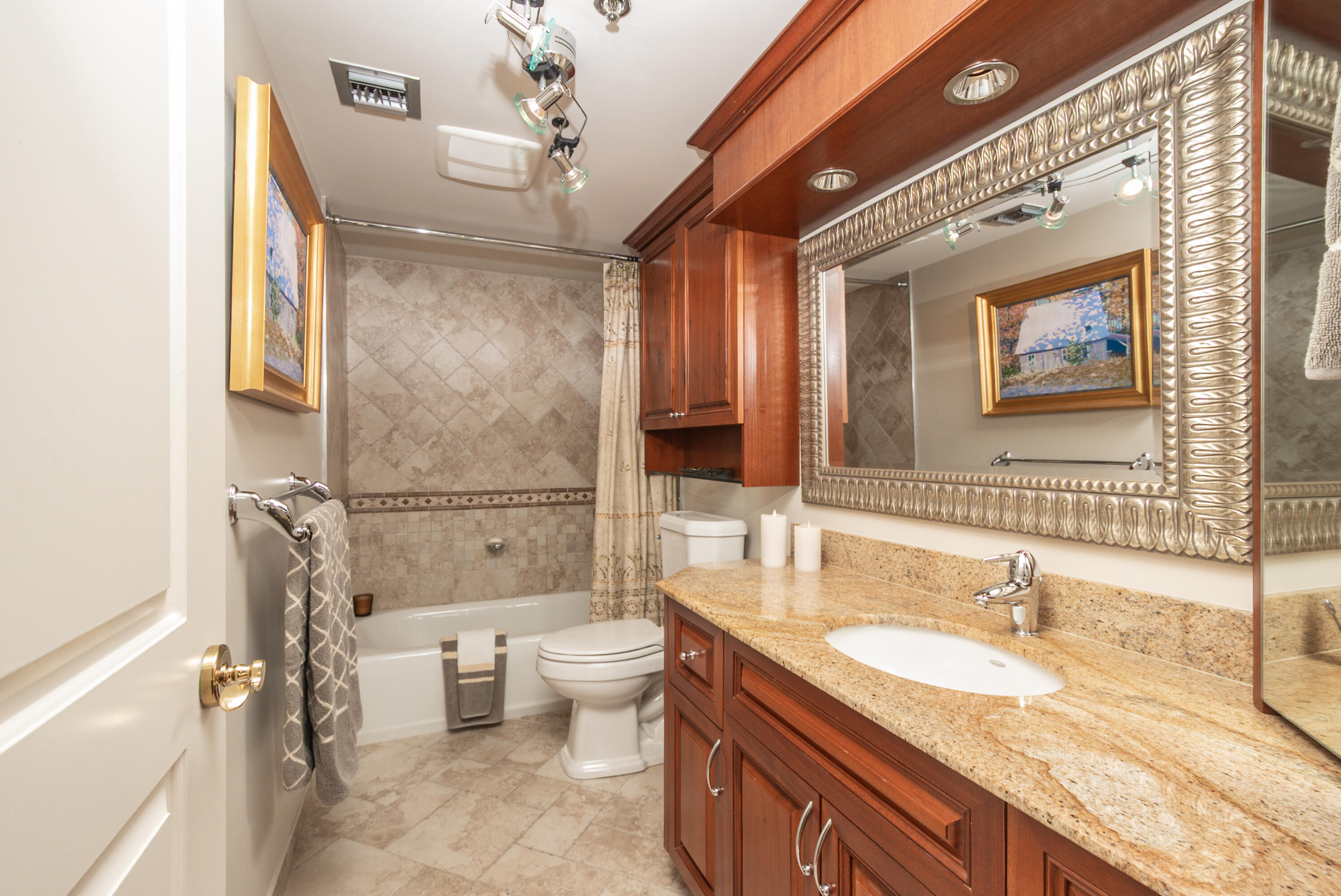 4748 South Ocean Boulevard, Unit 4B Highland Beach, FL 33487 - Photo 14 of 56 a bathroom with a granite countertop sink mirror vanity bathtub and toilet