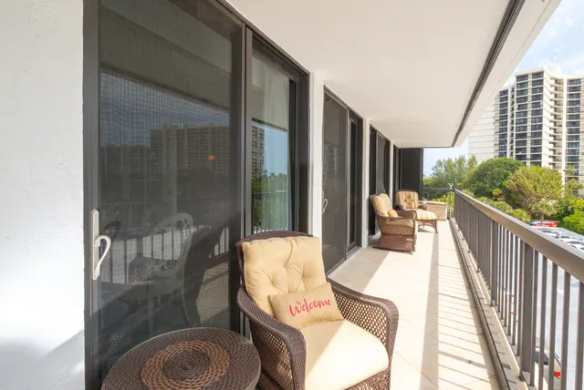 a view of a dining room with furniture a chandelier and wooden floor