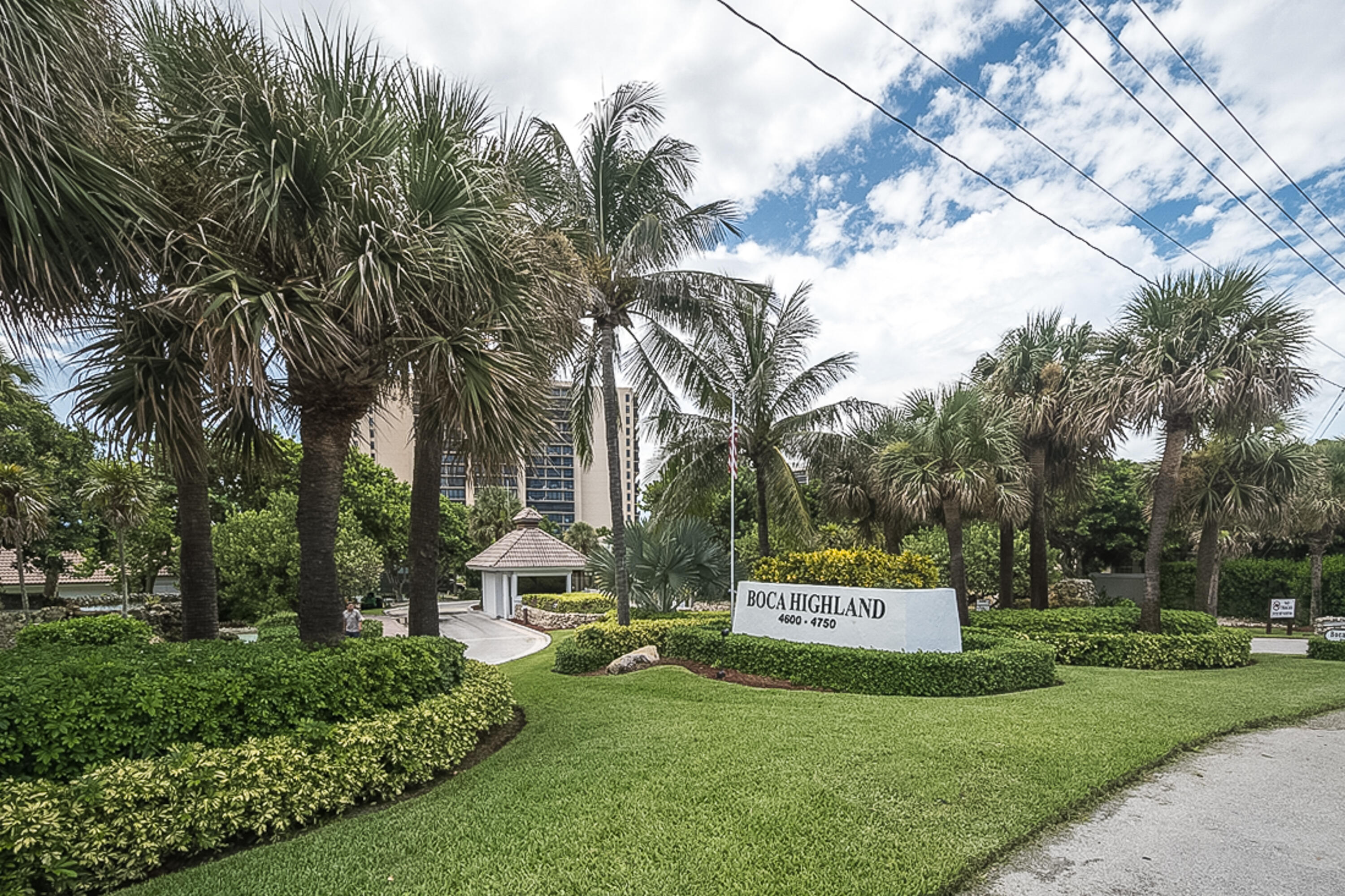 4748 South Ocean Boulevard, Unit 4B Highland Beach, FL 33487 - Photo 28 of 56 a sign that is sitting in front of a house with a big yard and large trees