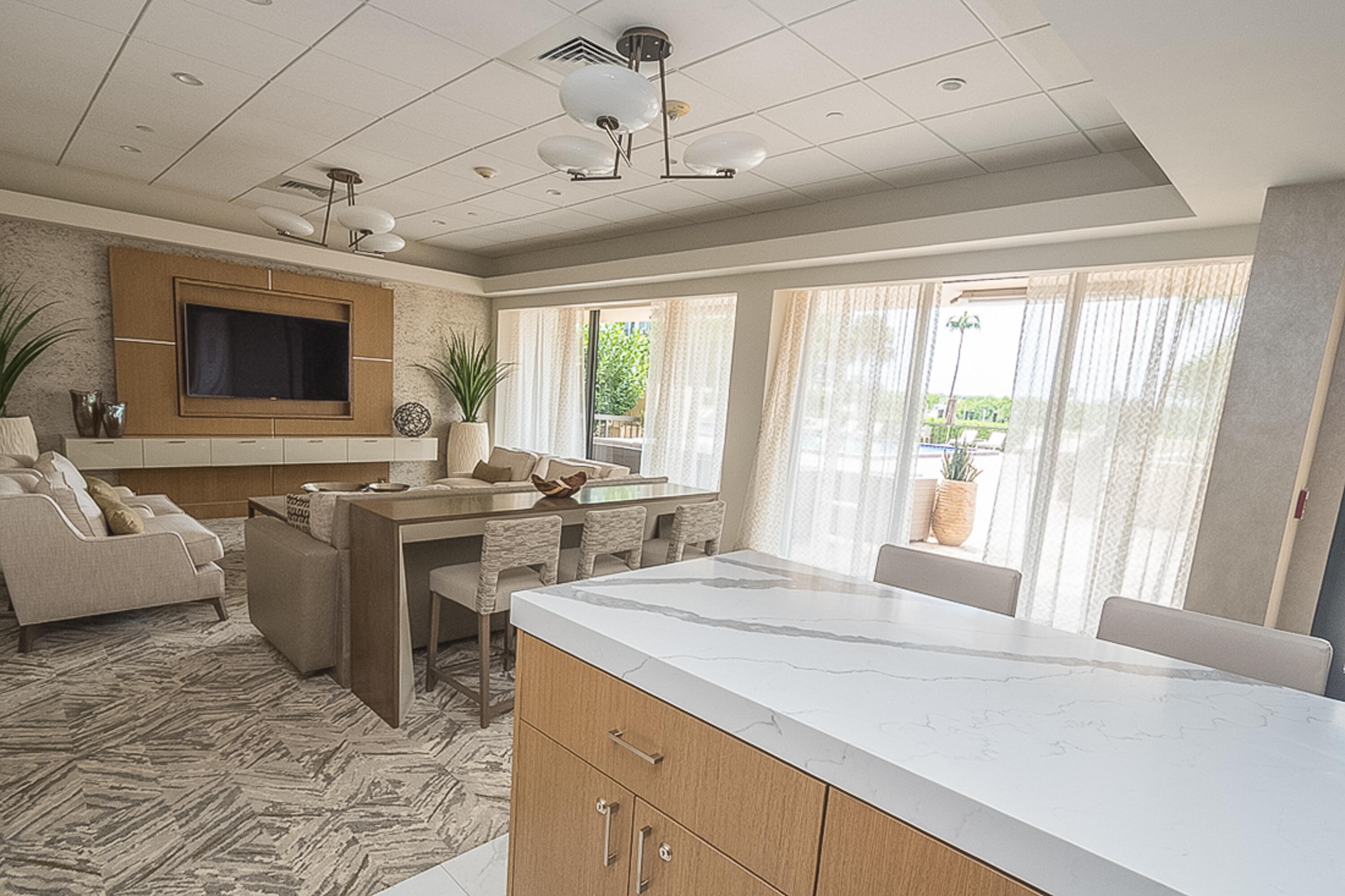 4748 South Ocean Boulevard, Unit 4B Highland Beach, FL 33487 - Photo 36 of 56 a view of a kitchen with kitchen island a large window cabinets a sink and stainless steel appliances