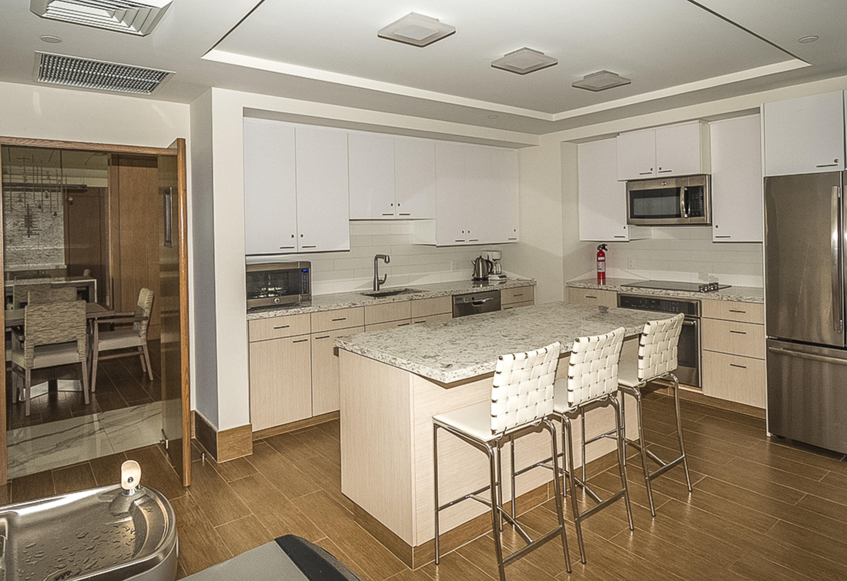 4748 South Ocean Boulevard, Unit 4B Highland Beach, FL 33487 - Photo 37 of 56 a kitchen with kitchen island a counter top space cabinets and stainless steel appliances