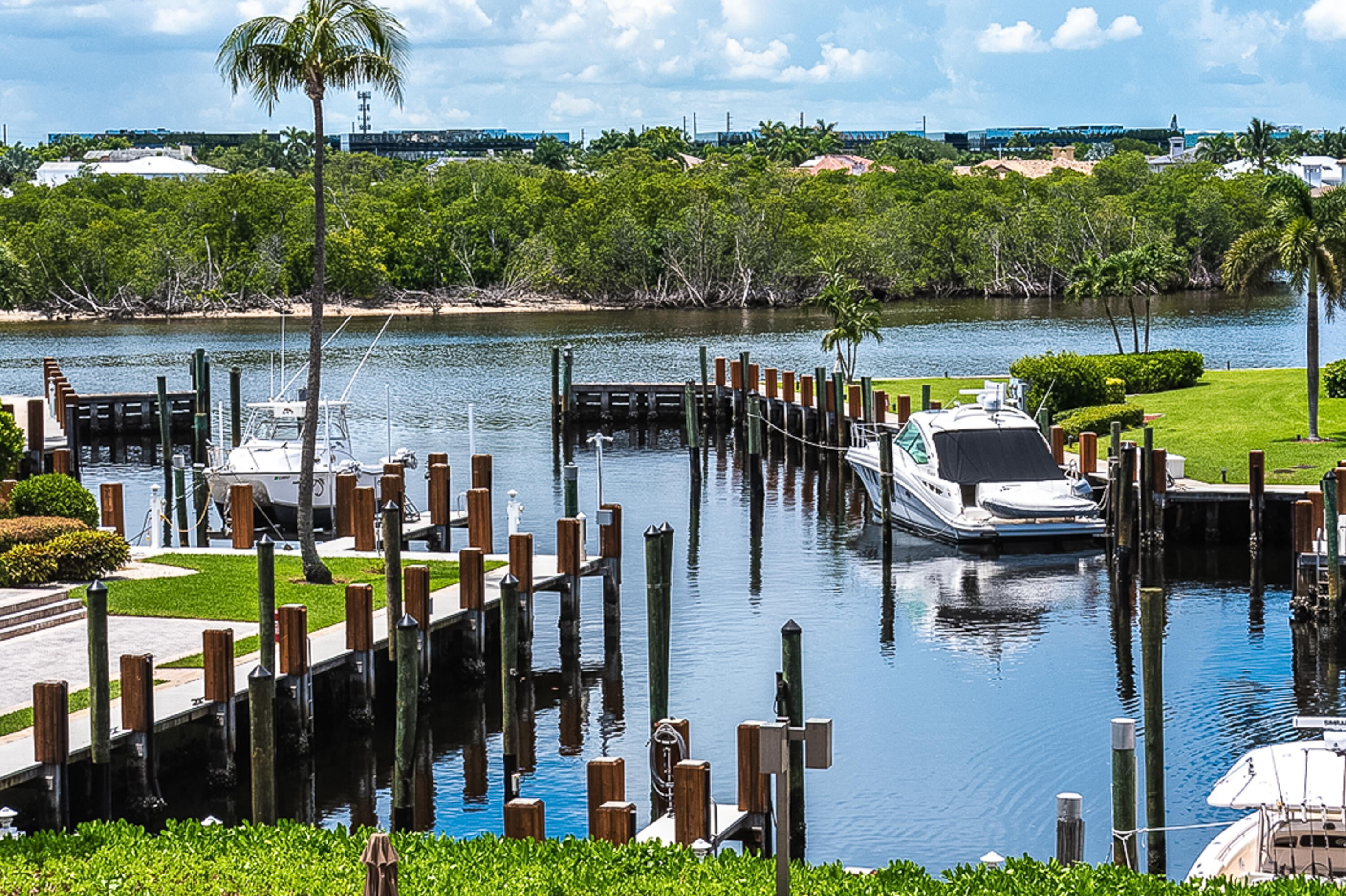 4748 South Ocean Boulevard, Unit 4B Highland Beach, FL 33487 - Photo 42 of 56 a view of a chairs and table in patio with a lake view