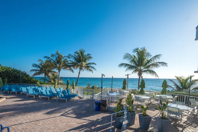 a large kitchen with stainless steel appliances kitchen island granite countertop a sink and cabinets