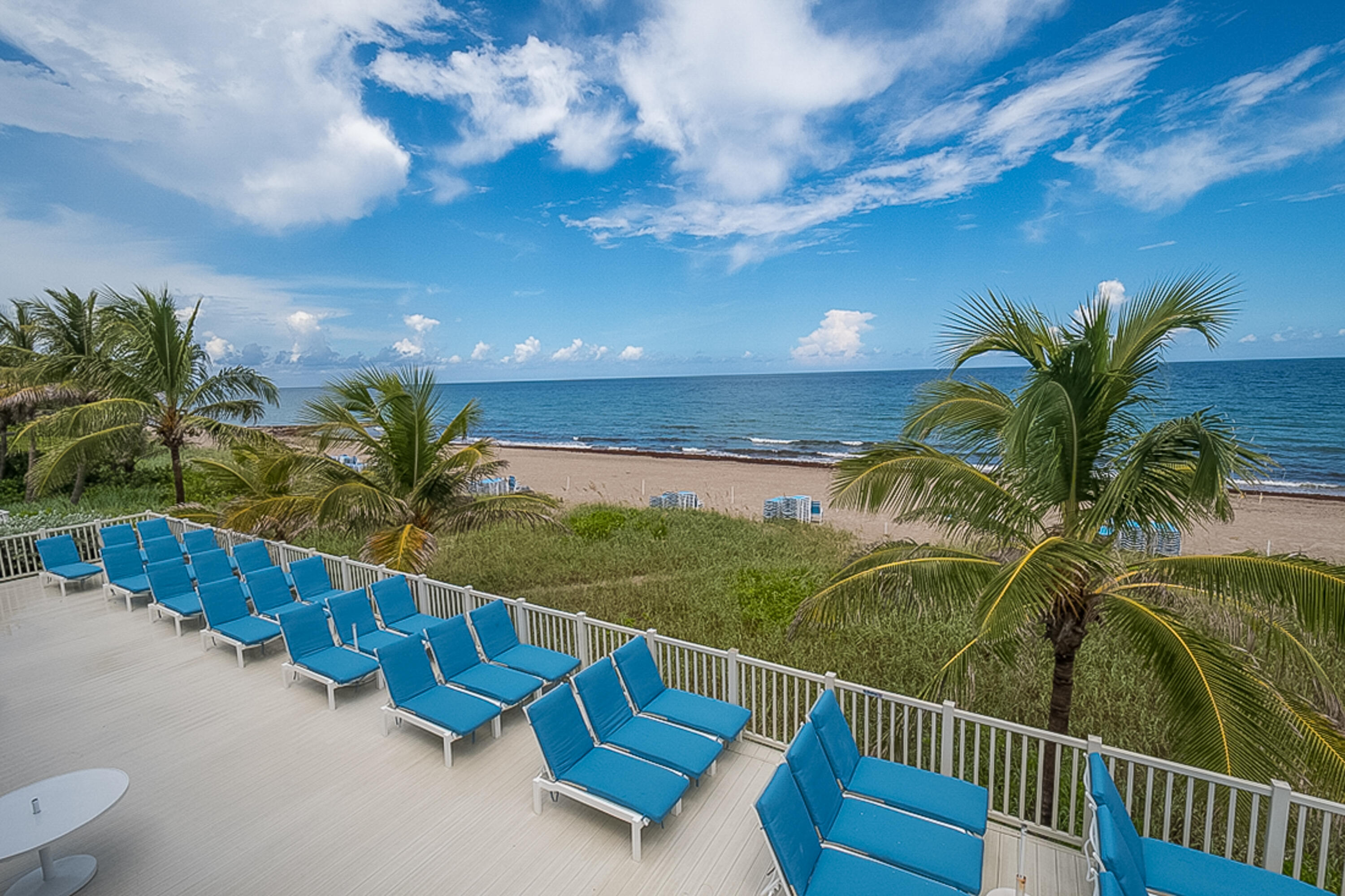 4748 South Ocean Boulevard, Unit 4B Highland Beach, FL 33487 - Photo 50 of 56 a view of a balcony with potted plants and palm tree