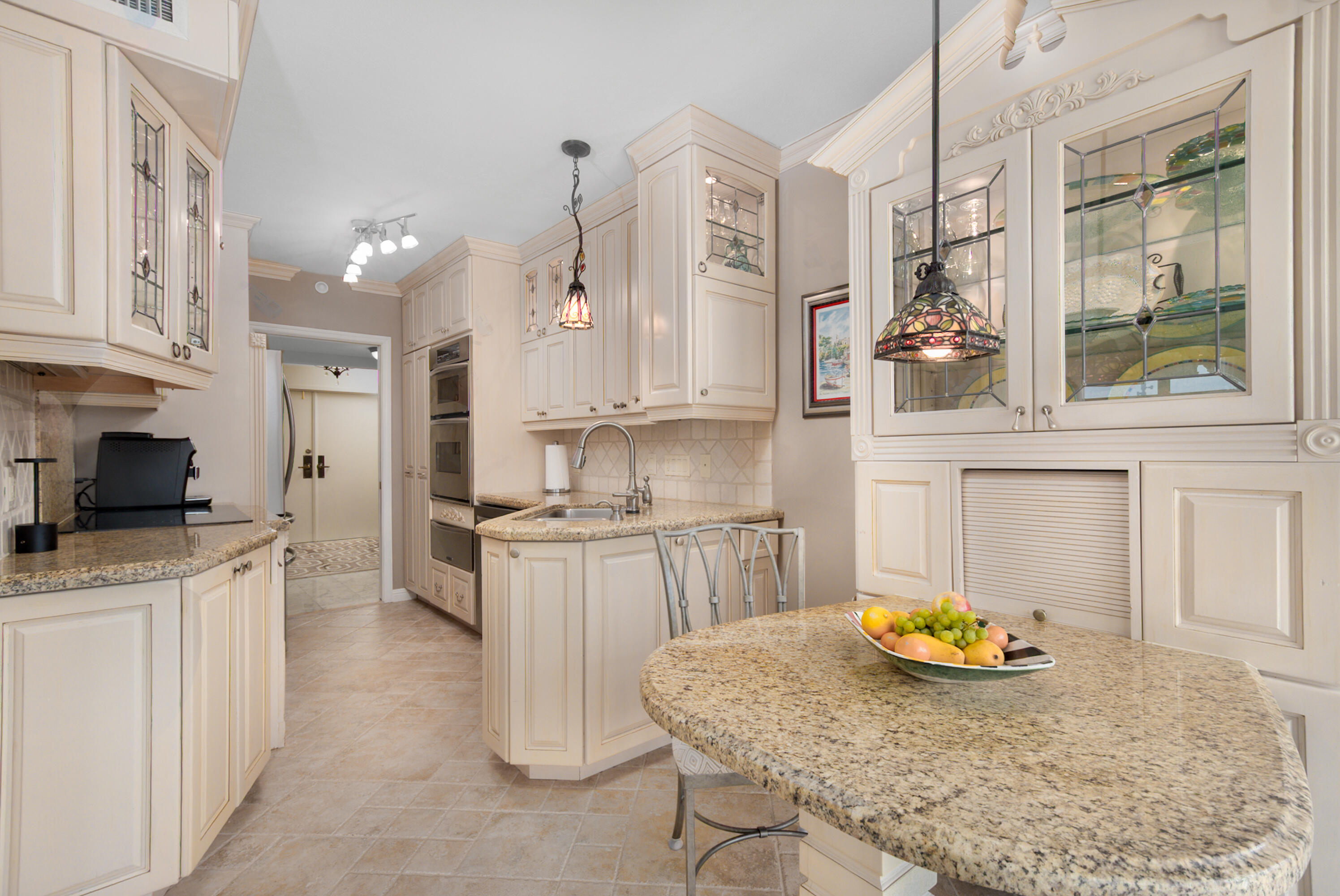 4748 South Ocean Boulevard, Unit 4B Highland Beach, FL 33487 - Photo 7 of 56 a kitchen with a sink a stove and cabinets