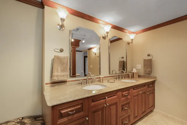 a bathroom with a granite countertop sink toilet and shower