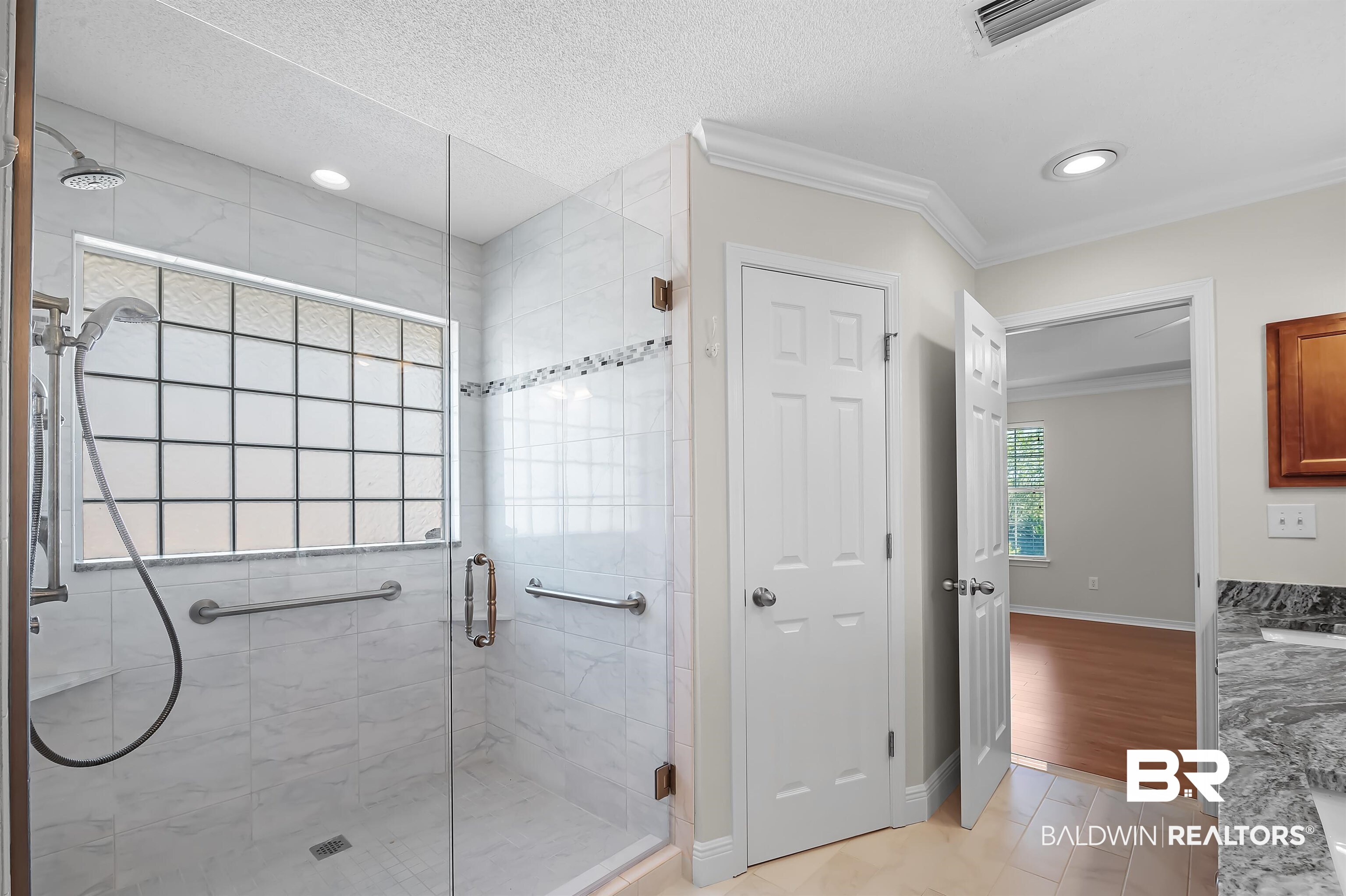 421 Collinwood Loop Foley, AL 36535 - Photo 38 of 62 Bathroom with crown molding, hardwood / wood-style flooring, walk in shower, and a textured ceiling