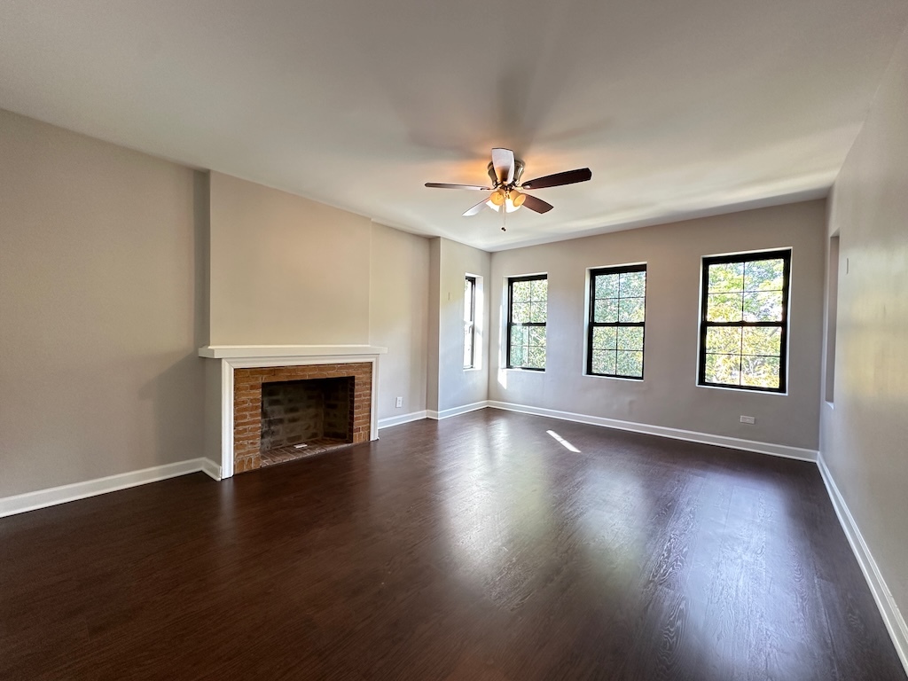 2617 West Rascher Avenue, Unit 2 Chicago, IL 60625 - Photo 11 of 20 an empty room with wooden floor fireplace and windows