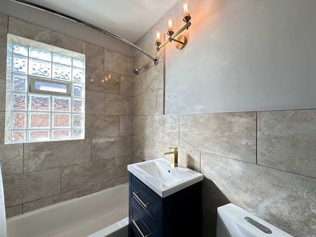 2617 West Rascher Avenue, Unit 2 Chicago, IL 60625 - Photo 20 of 20 a bathroom with a sink toilet and shower