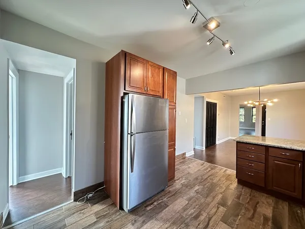 a kitchen with a refrigerator and a sink