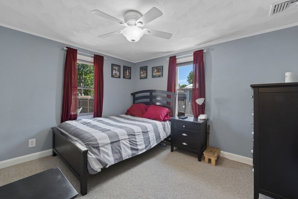 12 Sylvia Road Peabody, MA 01960 - Photo 15 of 42 a bedroom with a bed and a chandelier