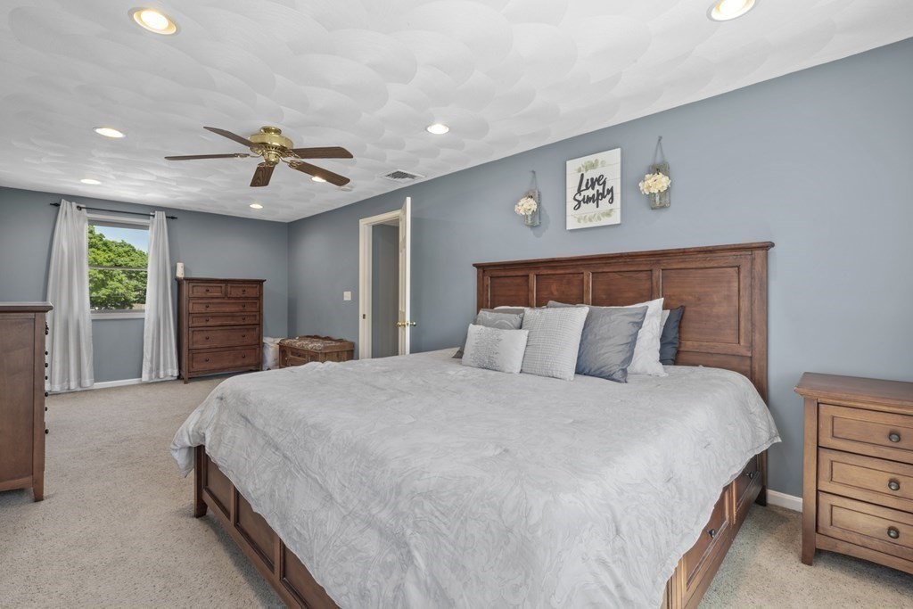 12 Sylvia Road Peabody, MA 01960 - Photo 23 of 42 a bedroom with a large bed and a chandelier