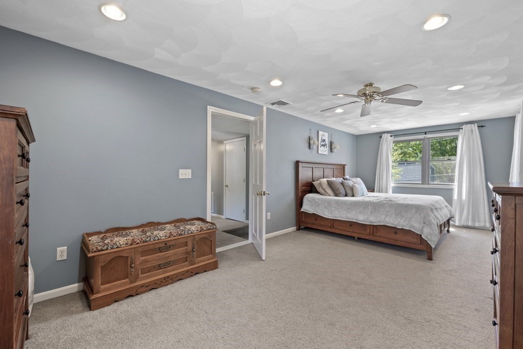 12 Sylvia Road Peabody, MA 01960 - Photo 25 of 42 a bedroom with a bed and a chandelier