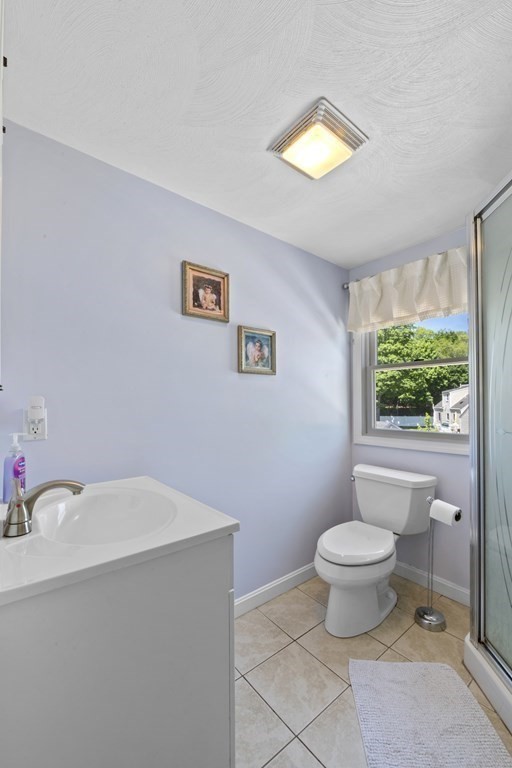 12 Sylvia Road Peabody, MA 01960 - Photo 26 of 42 a bathroom with a sink mirror vanity and a toilet
