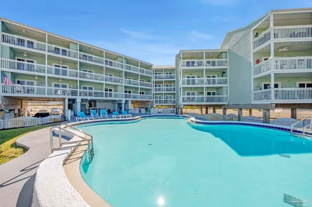 a swimming pool with outdoor view and sitting area