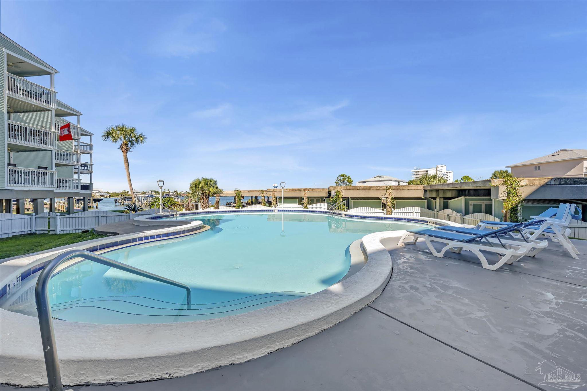 16310 Perdido Key Drive, Unit 9A Perdido Key, FL 32507 - Photo 18 of 26 a view of a swimming pool with a lounge chairs