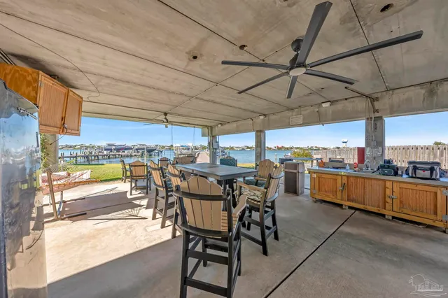 a view of a patio with dining table and chairs