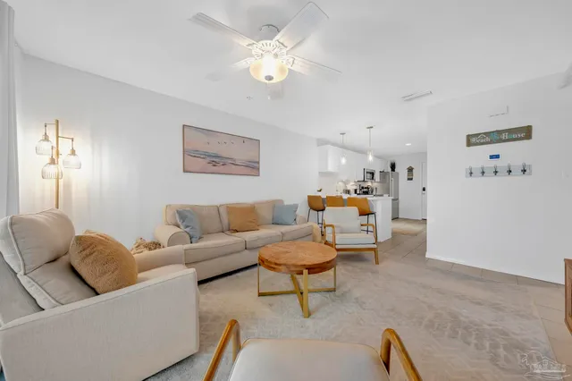 a living room with furniture and a chandelier